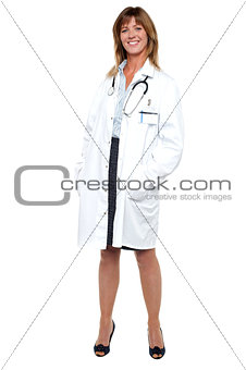 Smiling middle aged medical expert, full length portrait