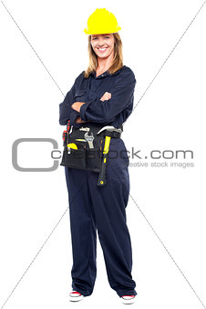 Confident woman with helmet and belt of tools