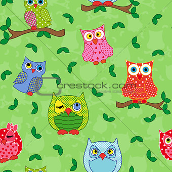 Seamless pattern with ornamental owls over light green