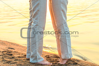 bare feet kissing couple at the sea