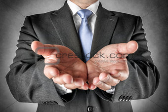 Businessman holds out hands