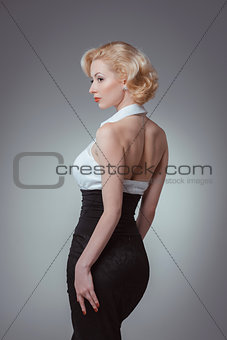 Pin-up girl young and beautiful woman portrait on gray background