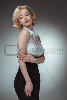 Pin-up girl young and beautiful woman portrait on gray background