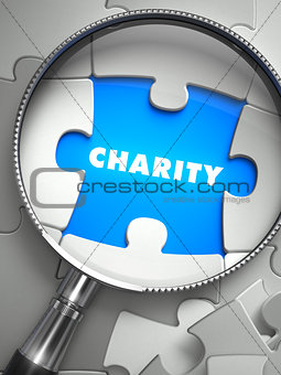 Charity - Puzzle with Missing Piece through Loupe.