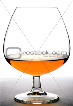 Glass with cognac on white background