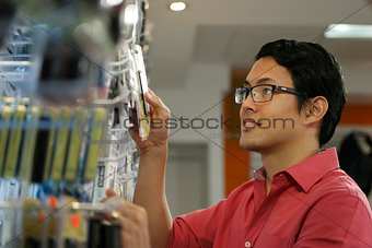 Happy Chinese Man Ordering Usb Drive In Computer Shop