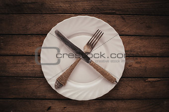 White shiny plate with folk and knife
