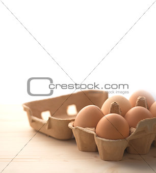 Eggs Over Wodden and White Background