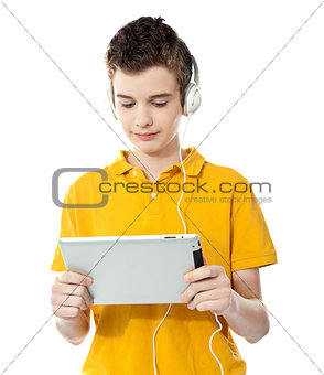 Boy listening to music on tablet pc