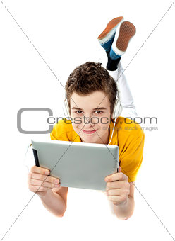 Boy lying on a floor with wireless device