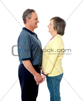 Aged couple in love holding hands
