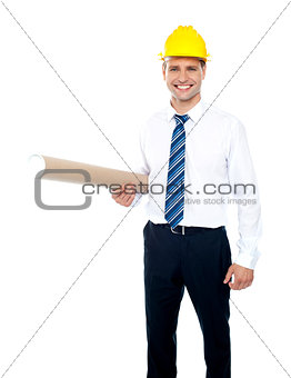 Successful male builder holding blueprints