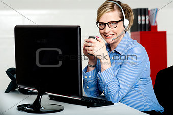 Aged businesswoman sipping coffee during break