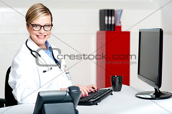 Female physician using computer