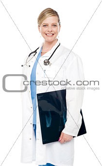 Smiling female surgeon carrying x-ray report