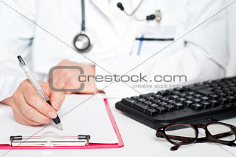 Closeup shot of female doctor writing prescription