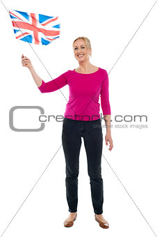Aged patriotic lady waving United Kingdom flag
