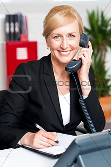 Corporate lady communicating on phone