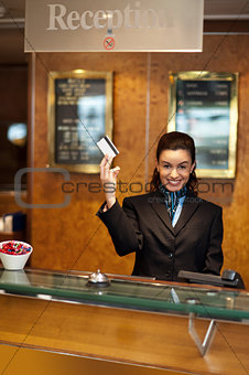 Beautiful receptionist posing with customers cash card
