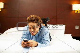 Excited young man waiting for message reply