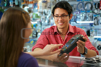 Customer Paying With Credit Card In Chinese Computer Shop