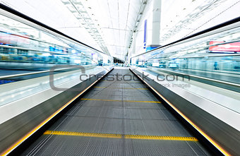 symmetric moving blue escalator inside contemporary airport