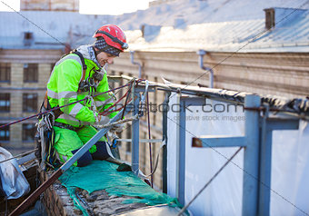 Industrial climber on a roof of a building