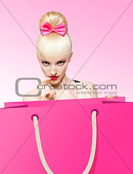 Glamorous girl with huge shopping bag on pink background