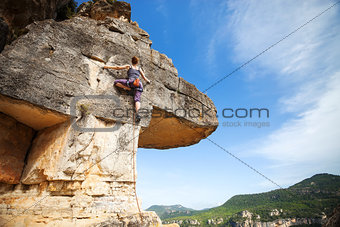 Woman climber on a cliff