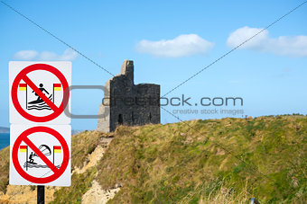 warning signs for surfers at ballybunion castle on the wild atlantic way in ireland