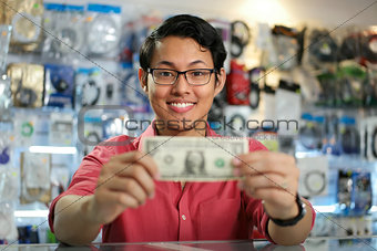 Happy Chinese Man Showing First Dollar Earning In PC Shop