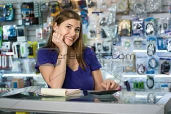 Woman Working As Computer Shop Owner Checking Bills And Invoices