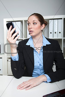 Businesslady looks at her smartphone