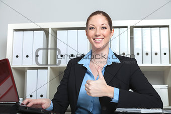Businesswoman holds thumb up