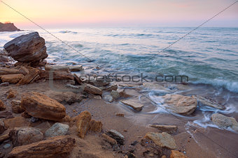 sunrise landscape,  the rocky sea coast and water waves