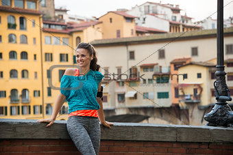 Fitness woman standing near ponte vecchio in florence, italy
