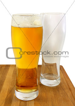 Glasses of light beer and empty glass
