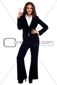 Woman in formals pointing upwards