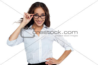 Smiling female executive adjusting her eye wear