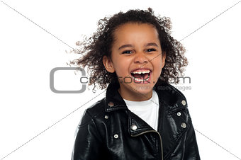 Profile shot of an elementary kid laughing heartily