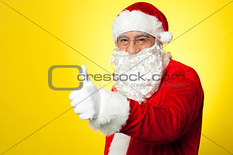 Santa showing thumbs up gesture to camera