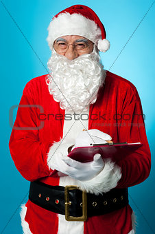 Santa Claus making his list of the good children