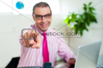 Smiling business professional pointing you out