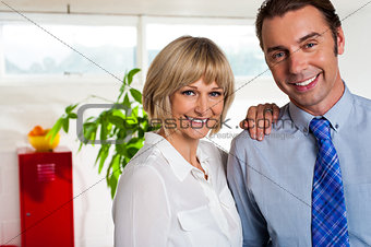 Cheerful business couple in their new office