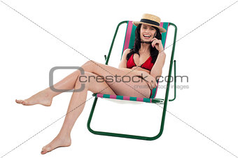 Seductive bikini woman relaxing on a deckchair