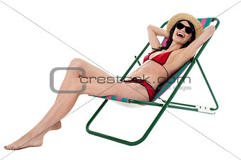 Cheerful young bikini model relaxing and having fun
