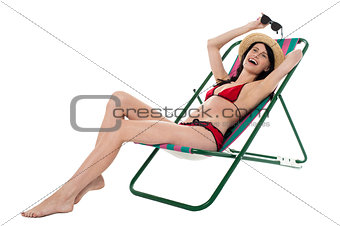 Full length portrait of relaxed cheerful bikini woman