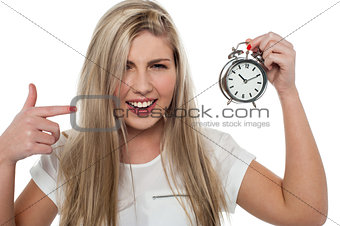 Girl pointing towards old fashioned time piece