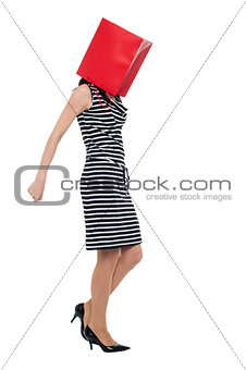 Woman covering her face with shopping bag