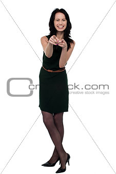 Pretty brunette in trendy wear pointing you out